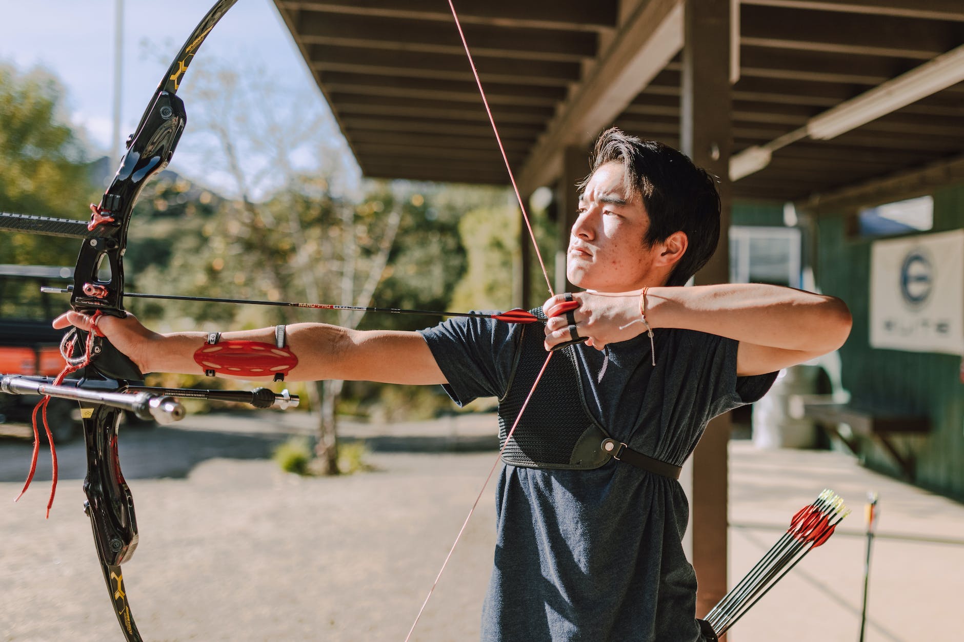 a male archer aiming a target