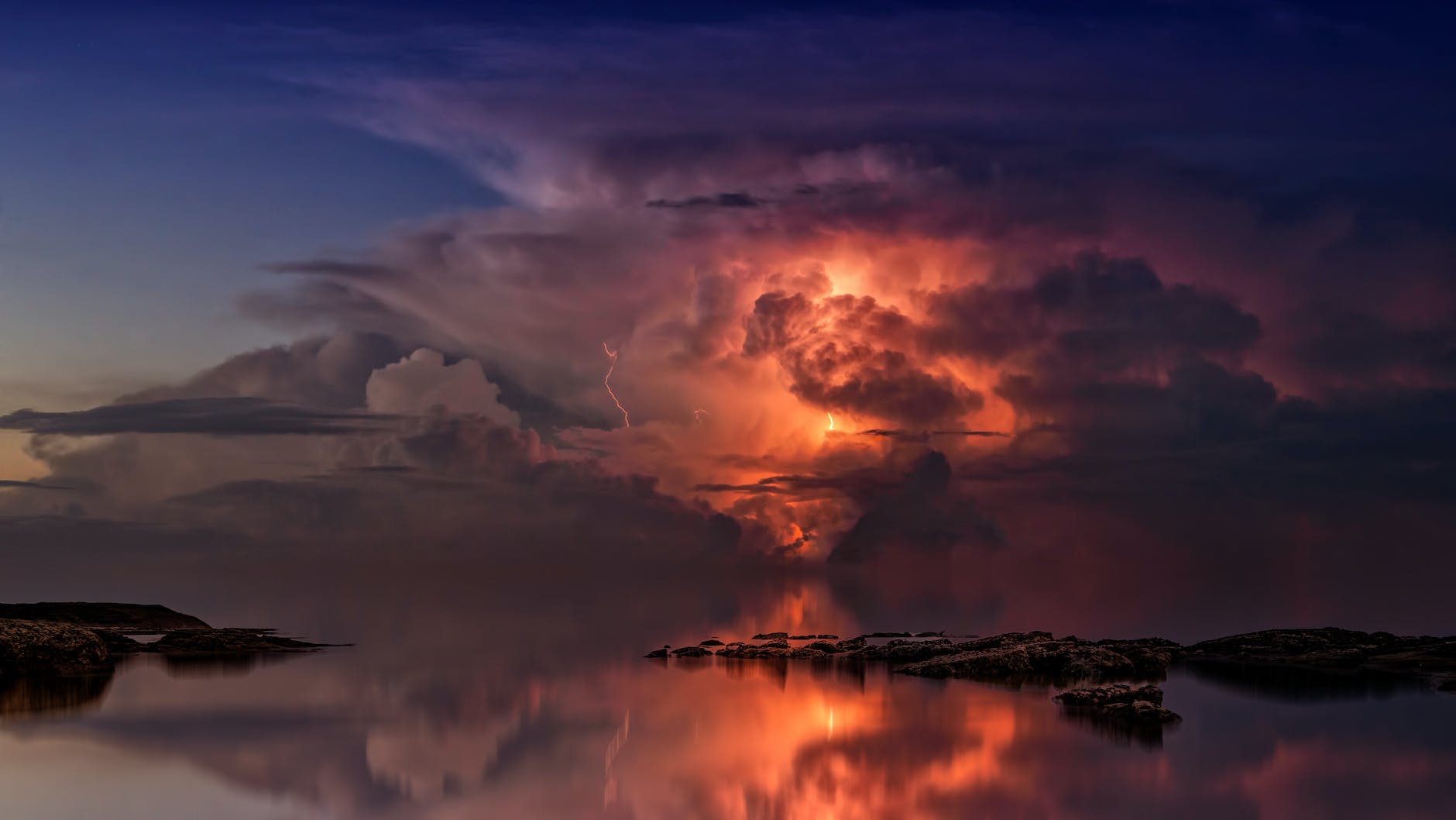 reflection of clouds on body of water