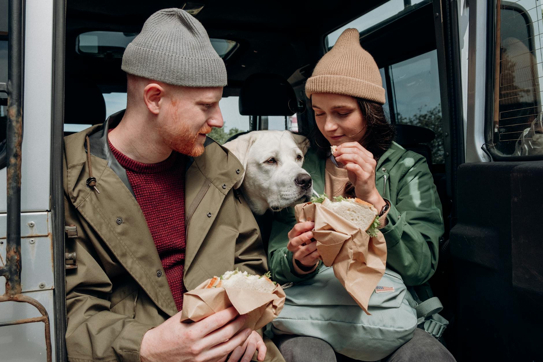 woman giving food to a dog