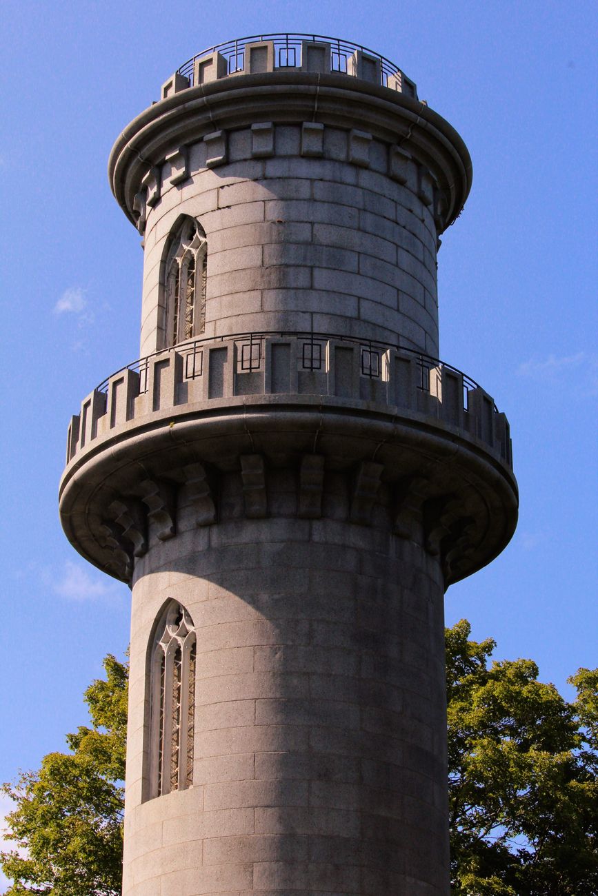 gray concrete tower under the blue sky